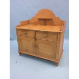 A Victorian stripped pine wash stand, raised back with overshelf, panelled cupboard base with two