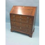 A George III oak bureau, fall-front enclosing an arrangement of drawers, pigeon-holes and central