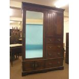 A late Victorian walnut Beaconsfield wardrobe, three-quarter-length mirror door alongside