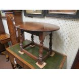 A solid, dark oak drop-leaf coffee table, on baluster-turned legs with plain stretchers, 1ft. 6in.