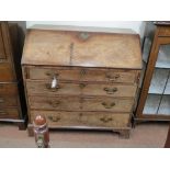 A George III mahogany bureau, fall-front enclosing an arrangement of drawers, pigeonholes and