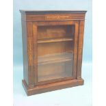 A Victorian inlaid walnut display cabinet, single glazed door enclosing lined interior with two