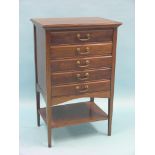 An Edwardian mahogany music chest, five fall-front drawers and open undertier, 1ft. 9in. - worm to