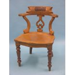 A Victorian light oak office chair, bow-back with carved initials, double-scroll splat, dished