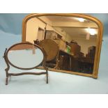 A Victorian moulded gilt overmantel, domed-shape, 3ft. 6in. wide, and an oval mahogany toilet mirror