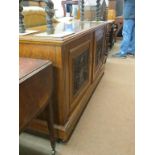 A late Victorian walnut sideboard, enclosed by a pair of carved and panelled doors, 5ft. - mirror