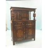 A solid, dark oak court cupboard, linenfold cupboard above panelled base with two drawers, 3ft.