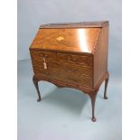 A good early 20th century mahogany bureau, on stand, cast brass gallery above inlaid fall-front,