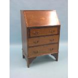 A small Edwardian inlaid mahogany bureau, fall-front enclosing fittings, three long drawers beneath,