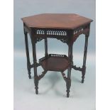 A late Victorian hexagonal mahogany occasional table, with pierced arch borders to frieze, on