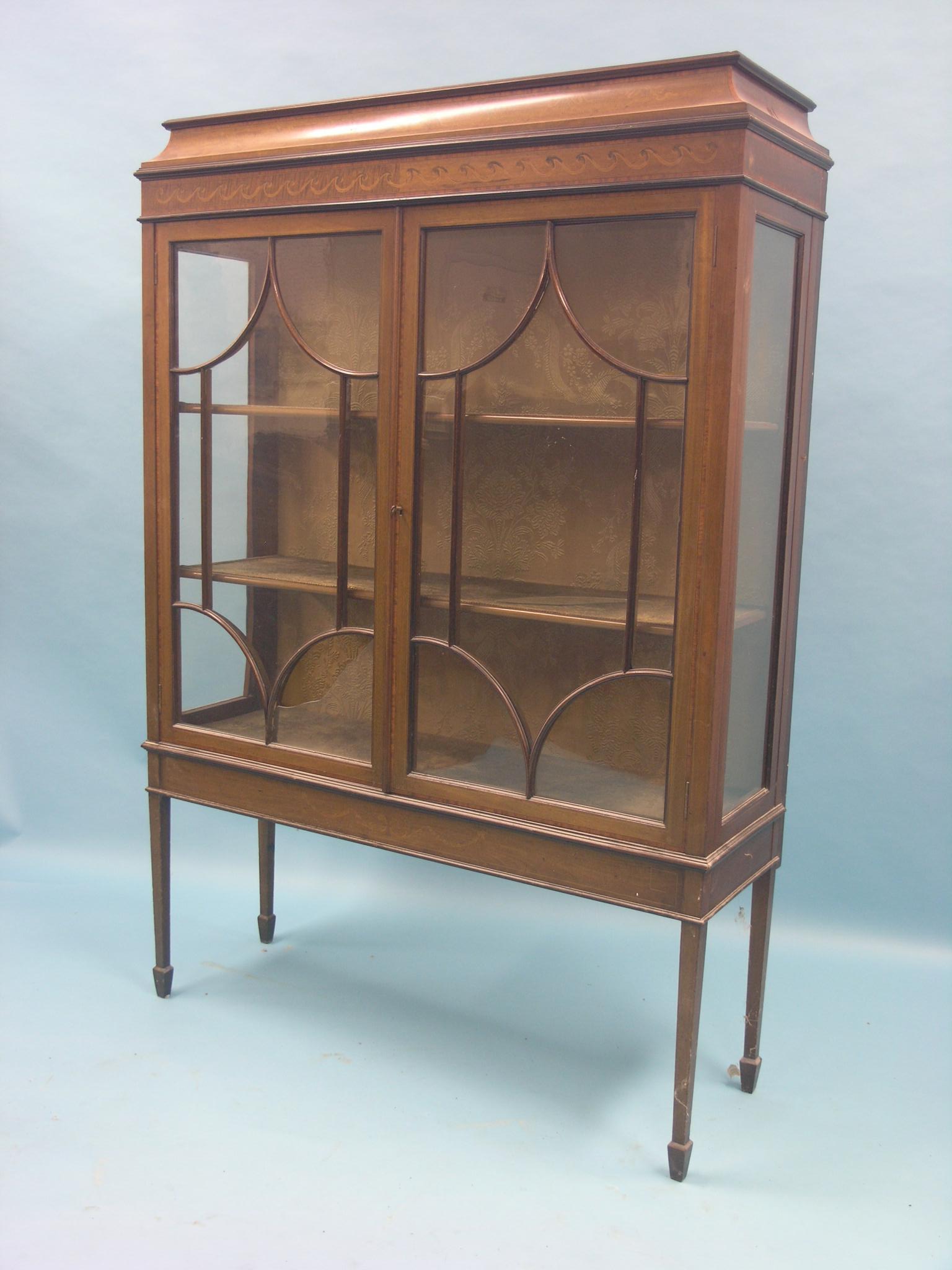 An Edwardian inlaid mahogany display cabinet, pair of astragal-glazed doors enclosing lined interior