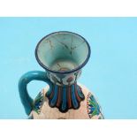 A pair of Longwy earthenware ewers, brightly enamelled, 10in. - one ewer repaired, pair of brass