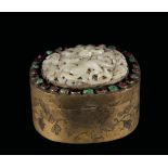 A gilt metal box with a white jade "dragon" plaque on the cover and semi-precious stones inlays,