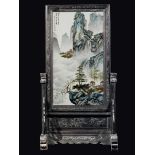 A large polychrome enammeled porcelain plaque depicting houses and mountain landscape with