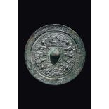 A bronze Bo Ju mirror with central boss, China, Han Dynasty (206 b.C-220 a.C.) cm 18,5