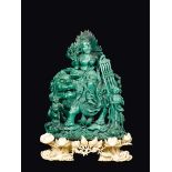 A finely carved malachite group with Guanyin on a Pho dog and children with carved ivory stand,