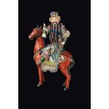 A polychrome enamelled porcelain figure of a warrior on a horse, China, Republic, 20th century h