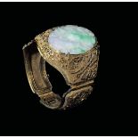 A bracelet with a jadeite plaque with naturalistic decoration, China, Qing Dynasty, 19th century