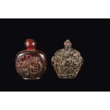 Two amber snuff bottles, one with cranes and one with figures in relief, China, Qing Dynasty, 19th