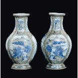 A pair of polychrome enamelled porcelain vases with blue and white reserves depicting river