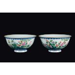 A pair of polychrome enamelled porcelain bowls with floral decoration, China, early 20th century