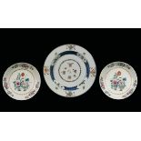 A large and a pair of polychrome enamelled porcelain dishes depicting flowers, China, Qing