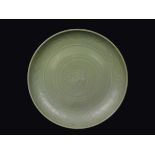 A Celadon porcelain dish with naturalistic decoration, China, Ming Dynasty, 16th century diam cm