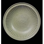 A Celadon porcelain dish with fluted lotus flower, China, Ming Dynasty, 17th century diam cm 32,5