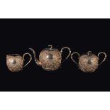 A silver tea set: teapot, sugar bowl and milk jug, China, Qing Dynasty, 19th century h da cm 7 a