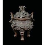A bronze tripod censer and cover with dragons and animals in relief, China, Qing Dynasty, 19th