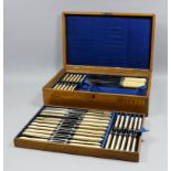 A set of twenty-four plated and ivory handled table knives and twenty-four matching smaller