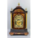 A late 19th Century rosewood and brass inlaid cased mantel clock, the arched brass dial with 6.75ins