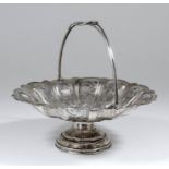 A late Victorian silver circular cake basket of shaped outline, the reeded body cast with scroll and