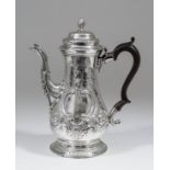 A George III silver baluster shaped coffee pot, the domed cover with spiral fluted finial and leaf