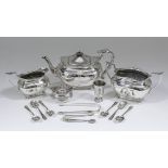 A late Victorian silver three piece rectangular tea service, the shaped rims with scroll mounts