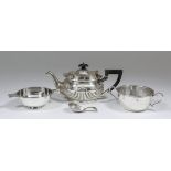 An Edward VII silver oval teapot with part reeded lid and body, ebonised finial and angular