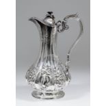 A Victorian plated baluster shaped claret jug with cast floral leaf finial, the reeded body emb with