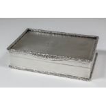 A George V silver rectangular table snuff box with floral and leaf cast mounts and engine turned