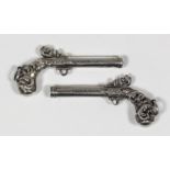 A pair of Victorian silvery metal miniature duelling pistol propelling pencils with scroll emb