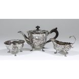 A late Victorian silver circular teapot with shaped rim and moulded girdle to body, the whole