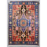 A modern Turkish rug of Caucasian design woven in colours with a bold central angular medallion with