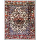 An antique Isfahan rug, woven in colours with double headed scrolled medallion, conforming spandrals
