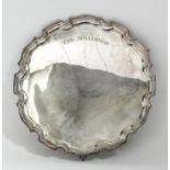 A George V silver circular salver with moulded piecrust rim and on three claw and ball feet, 14ins