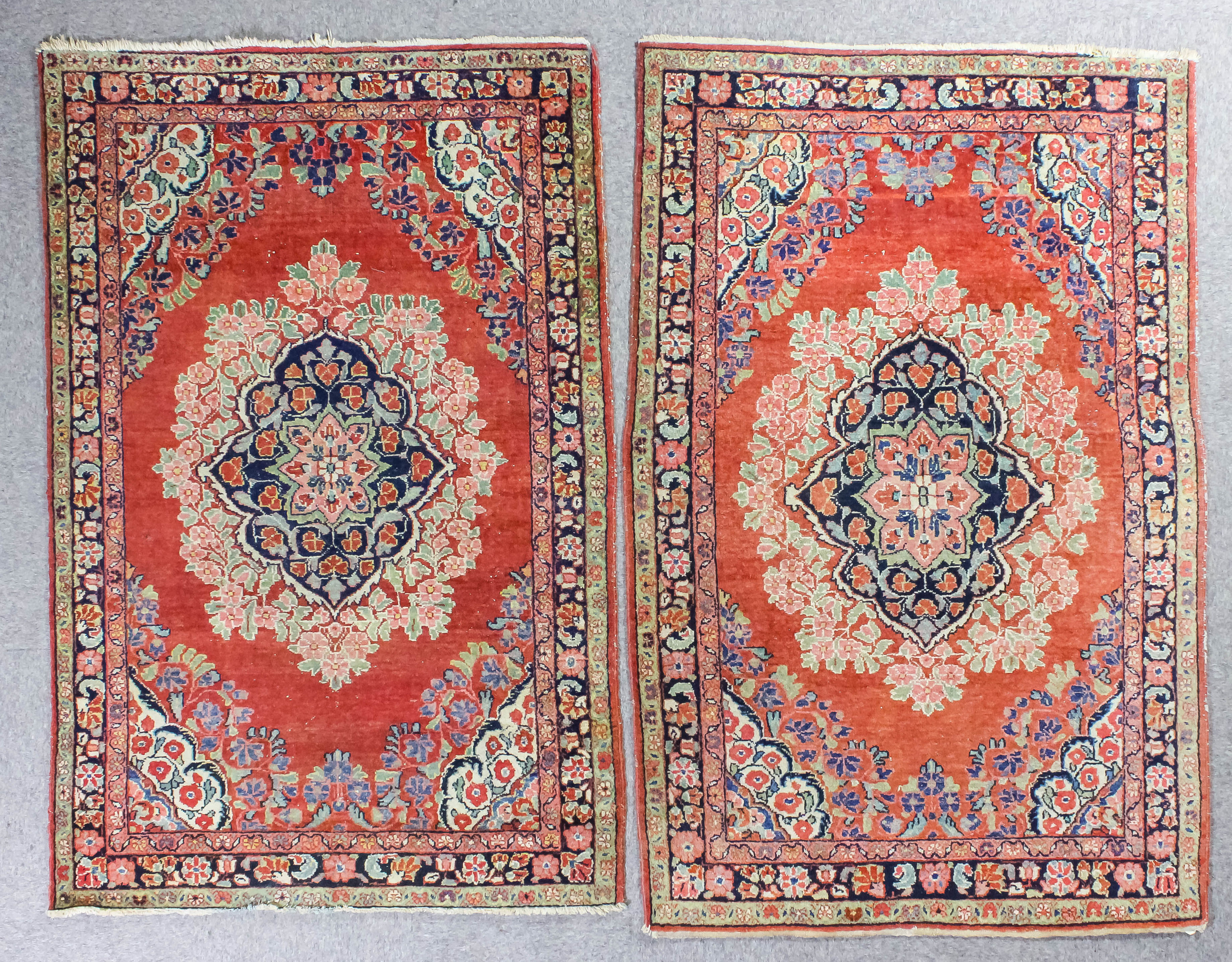 Two Tabriz rug of similar design each woven in colours with bold central oval medallion within