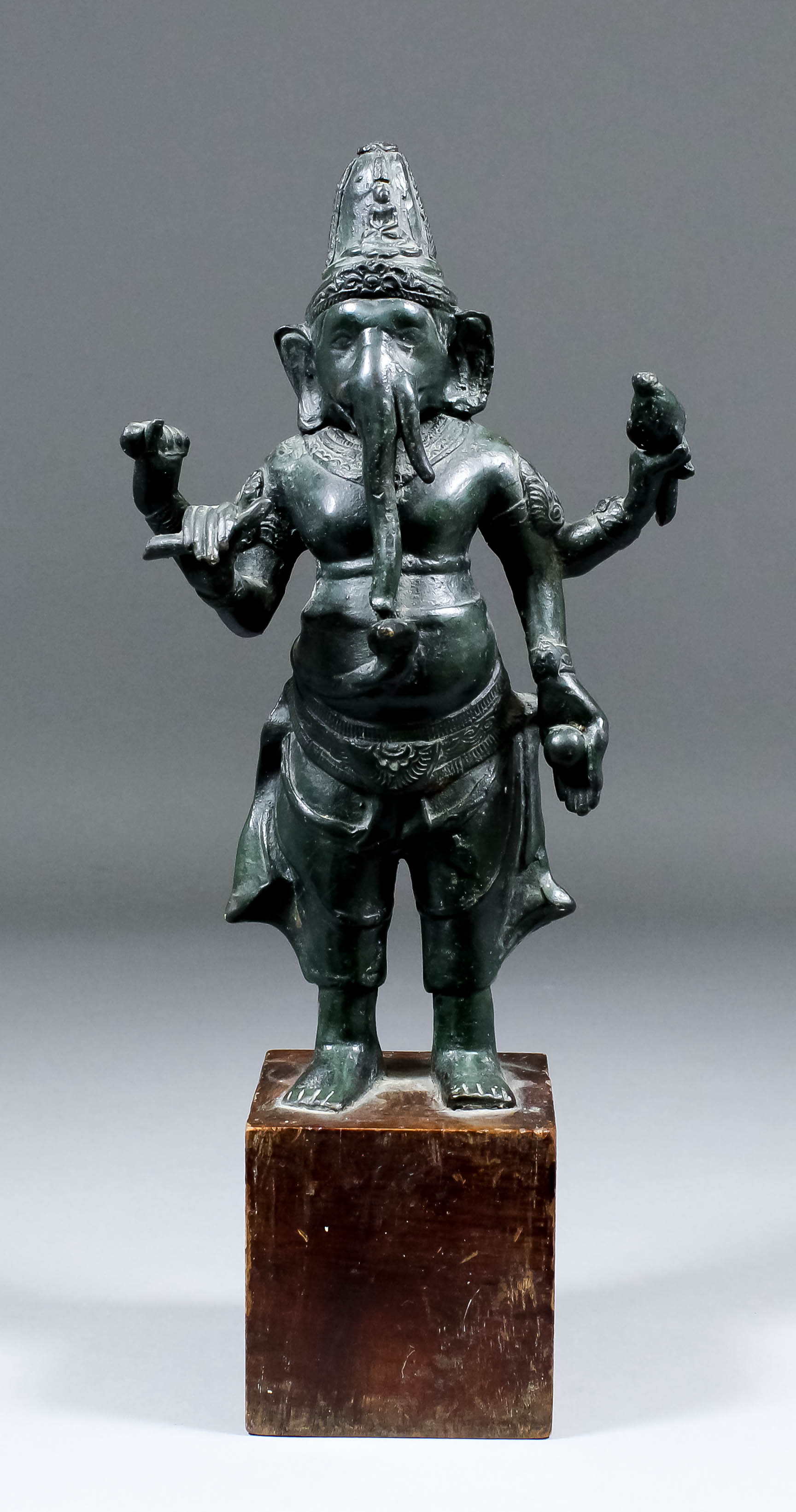 An Indian bronze standing figure of "Ganesh" (the elephant headed Hindu God), 9.75ins high, fixed to