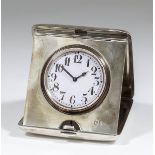 A George V silver cased travelling timepiece, the 1.875ins white enamelled dial with Arabic numerals