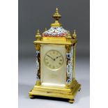 A late 19th/early 20th Century French gilt brass and champleve enamel cased mantel clock by E.M. &