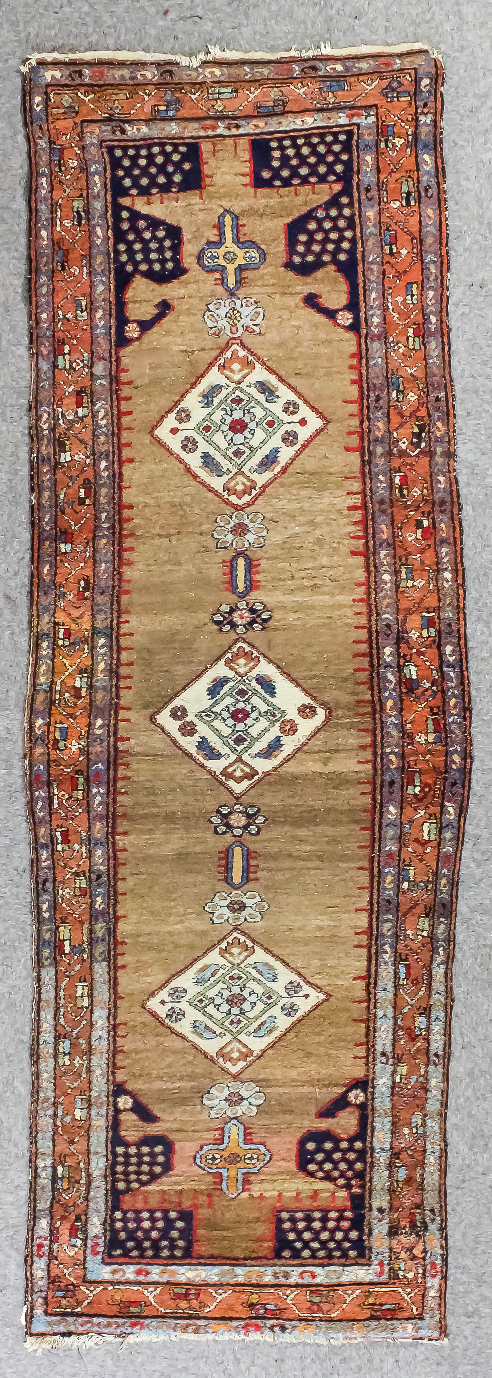 A Sarape runner woven in colours with a central pole medallion with three lozenge shaped panels,