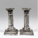 A pair of Edward VII silver pillar candlesticks with Corinthian capitols and spiral fluted