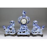 A 19th Century blue and white Delft three piece clock garniture, the clock with movement by S. Marti